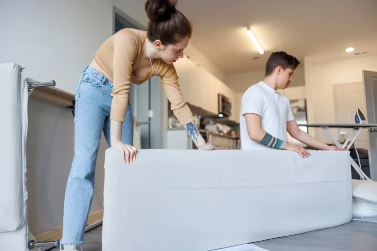 man and woman trying to asemble bed from ikea
