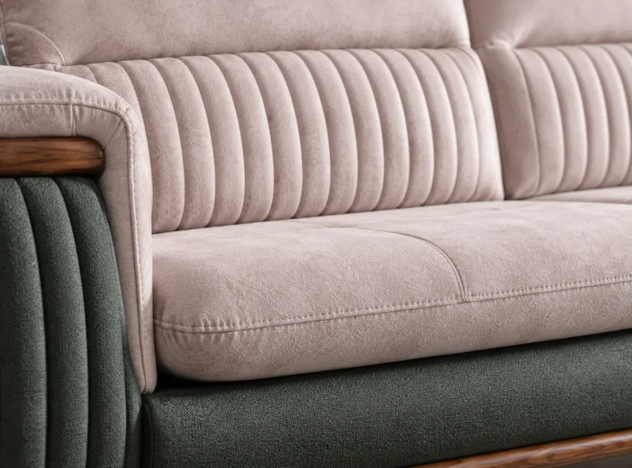 Aston L-shaped Sofa - fabric close-up, styled image Aston L-shaped sofa channel-stitched blush fabric and green base close-up, styled image
